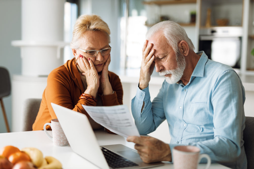 Worried senior couple feeling stressed while have to pay their medical bills over Internet